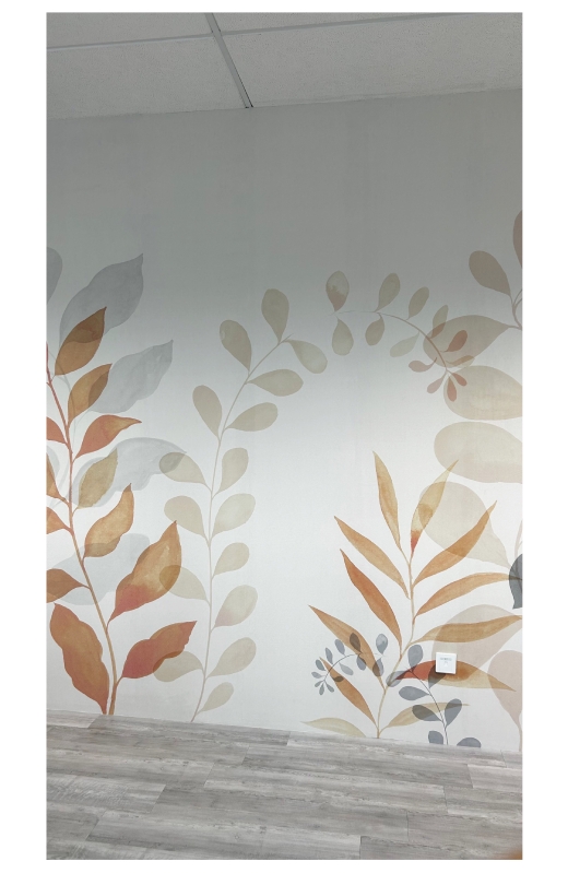 Finished botanical wallpaper installation with soft pastel leaves in an office, featuring a natural, airy design
